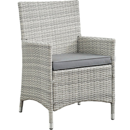 Light gray woven outdoor armchair with high back and gray cushioned seat, metal-tipped legs, from a 4-piece patio conversation set.