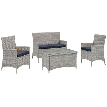 Gray wicker outdoor seating set with navy cushions: loveseat, two armchairs, and glass-top coffee table