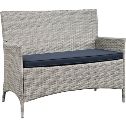 Light gray synthetic wicker 4-piece outdoor conversation set with navy cushions, weatherproof seating; loveseat with straight back & armrests.