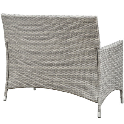 Grey synthetic wicker outdoor four-piece conversation set for patio, featuring curved-back seating and integrated armrests.