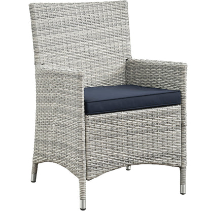 Light gray wicker 4-piece outdoor conversation set with navy cushions; high-back seating with straight arms and metal-tipped feet.