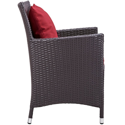 Dark brown woven rattan outdoor dining chair with red cushion, curved back and square arms for patio use