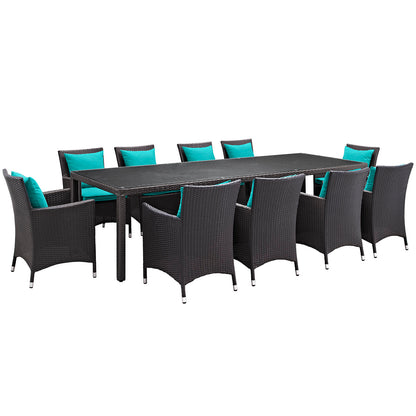 Espresso all-weather wicker outdoor dining set with rectangular table and turquoise cushions.