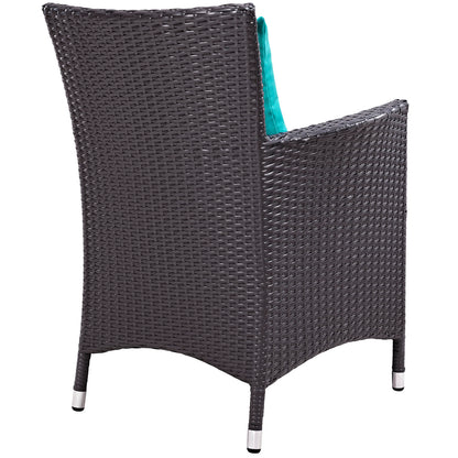 Espresso brown woven outdoor chair with teal cushion; tall curved back and metal-capped legs.