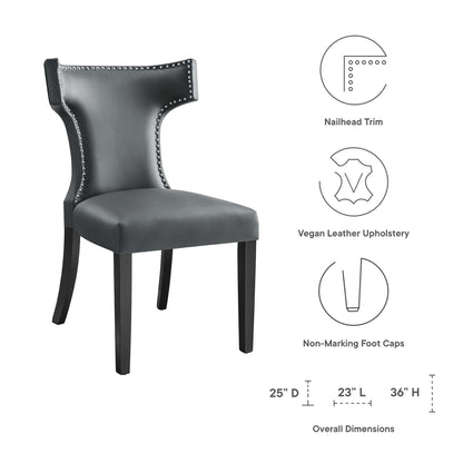 Gray vegan leather dining chair with nailhead trim, curved back, dark wood legs, non-marking foot caps; 36" H.