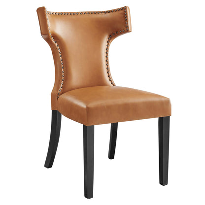 Tan vegan leather dining chair with high curved back, nailhead trim, and black wood legs.