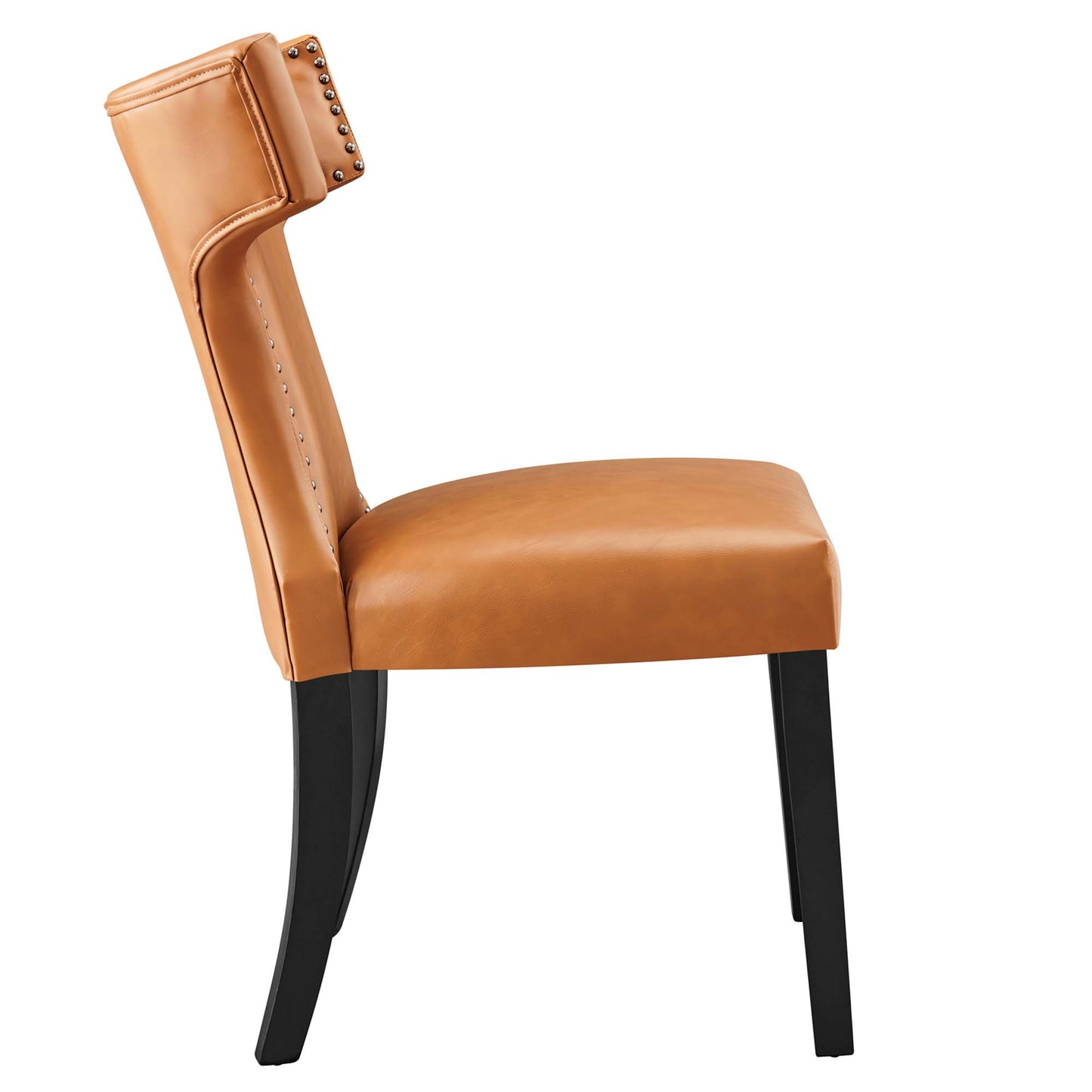 Tan vegan leather dining chair with a studded back, cushioned seat, curved back and dark wood legs