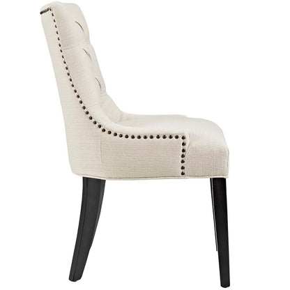 Brown tufted fabric dining chair with nailhead trim along the edge, curved high back & dark wood legs (side profile).