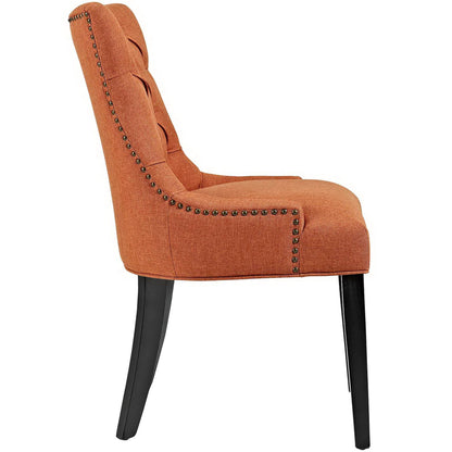 Orange fabric tufted dining chair with curved back, padded seat, black tapered legs.