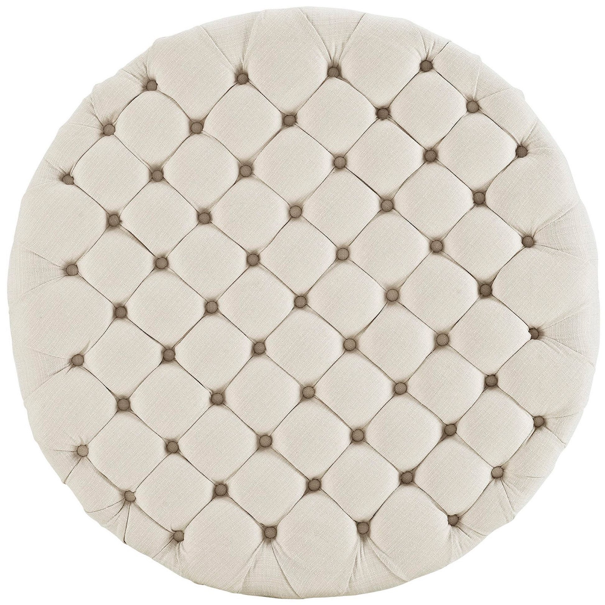 Round beige tufted ottoman with a diamond quilted pattern and small center buttons.