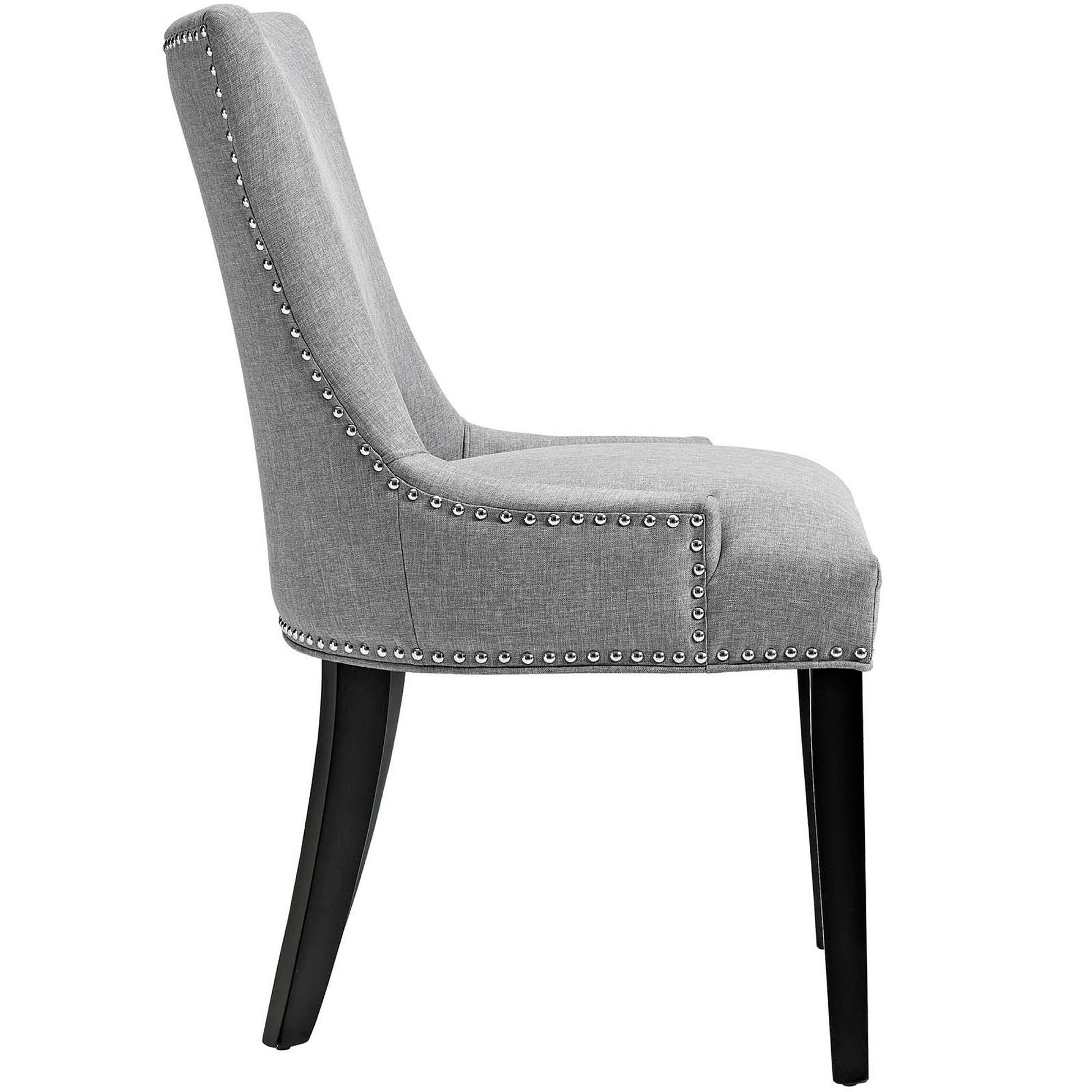 Grey upholstered dining chair with curved high back, nailhead trim, and dark wooden legs.