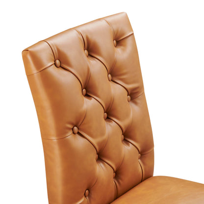 Tan vegan leather dining chair with tufted backrest and button cushions.