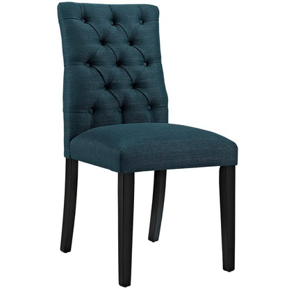 Teal tufted dining chair with button back and dark wood legs.