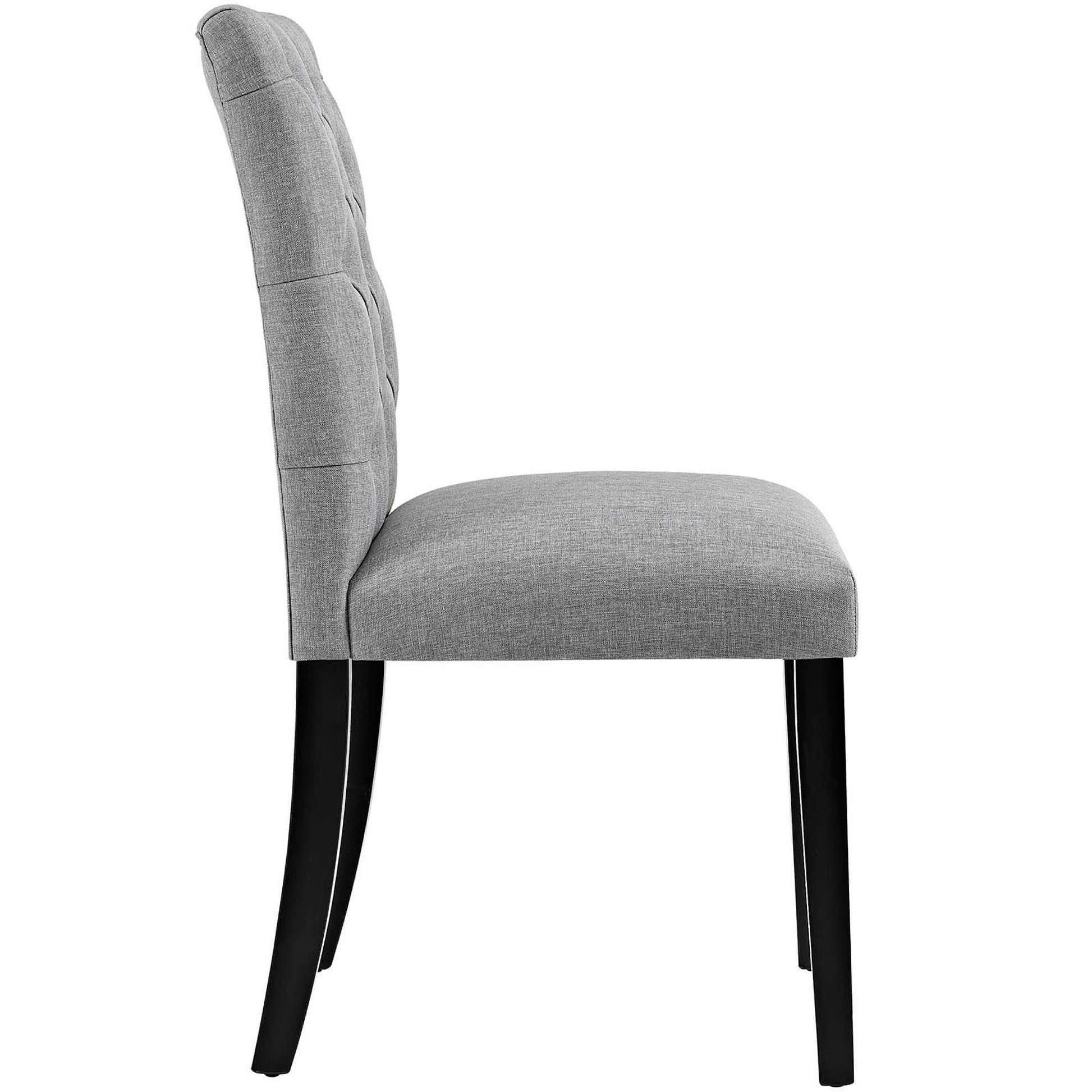Gray fabric upholstered dining chair with tall button-tufted back and black wood legs.