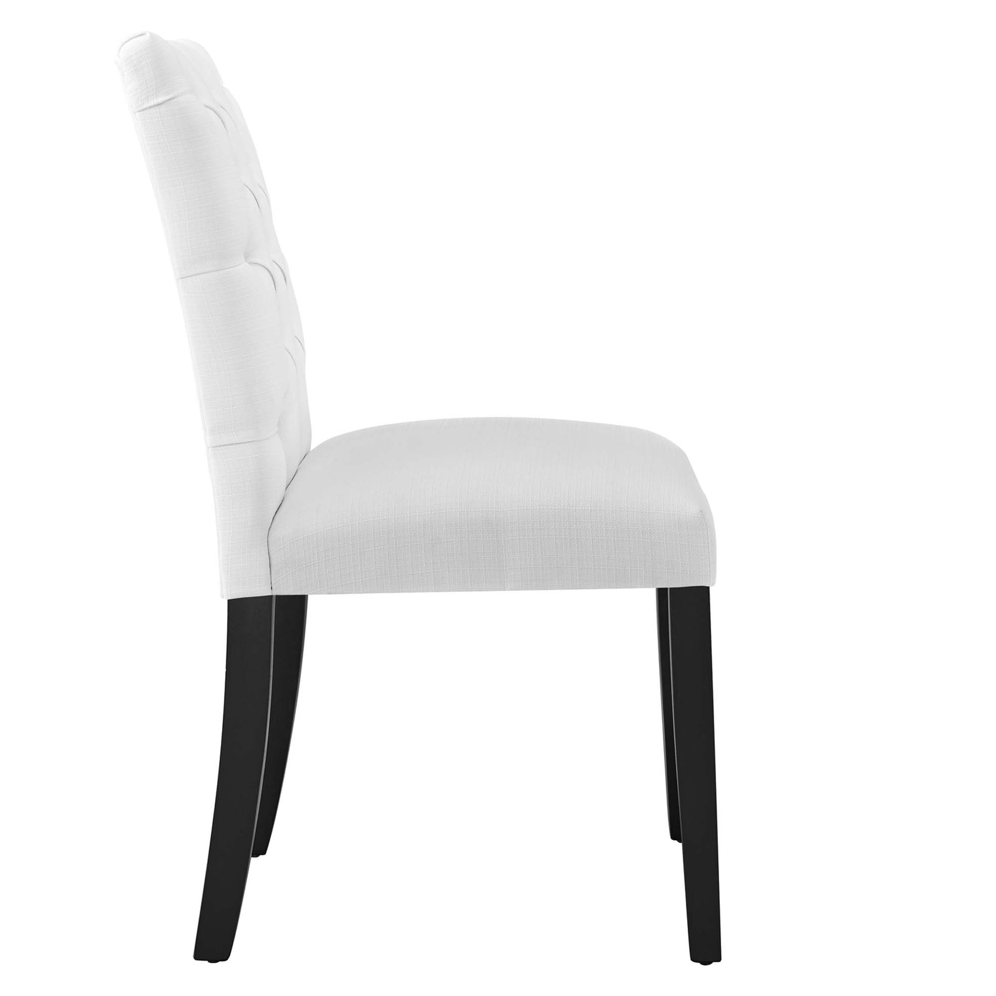 White upholstered dining chair with tufted back, padded seat, and dark wooden legs, side view.