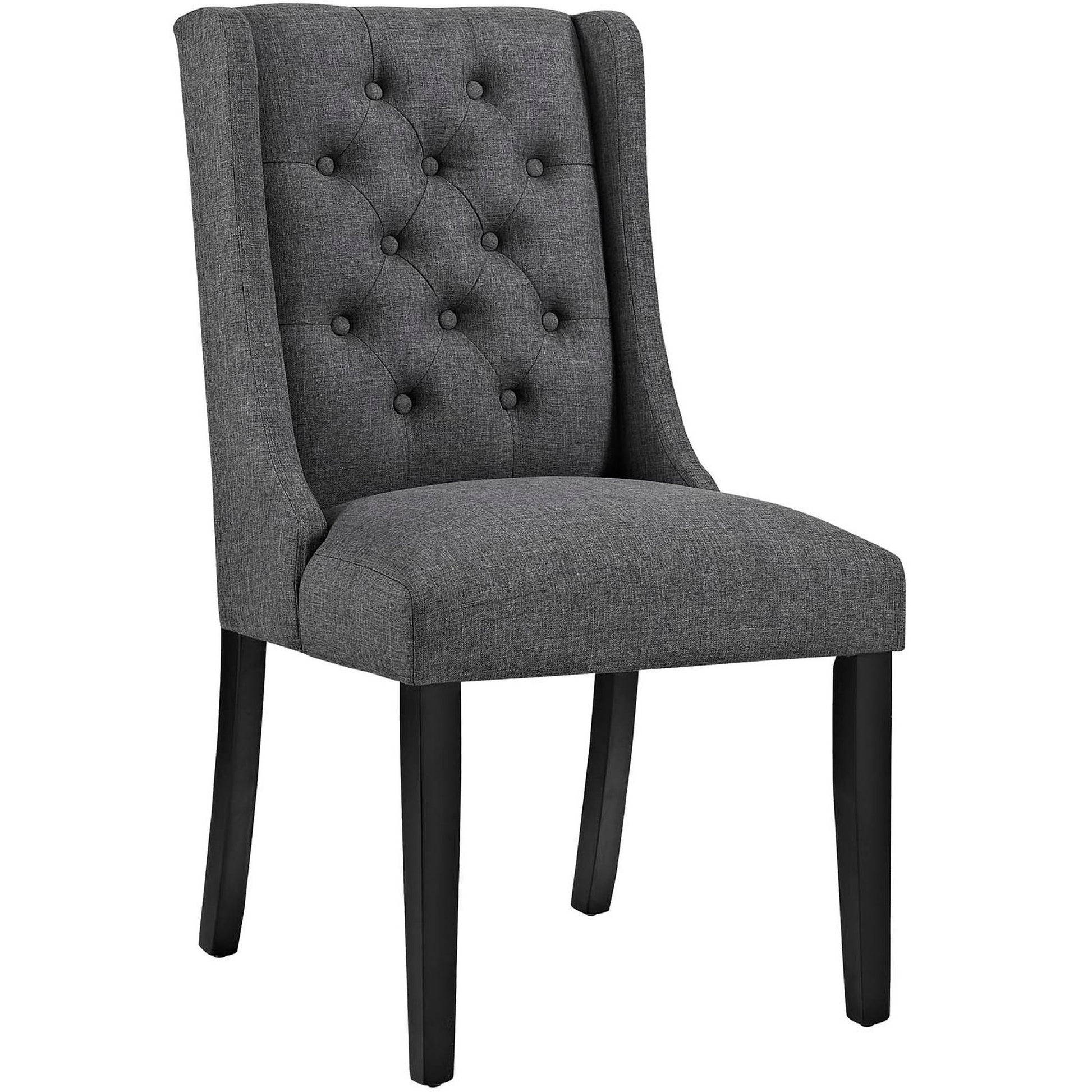 Gray fabric tufted dining chair with wingback, cushioned seat and black wood legs.