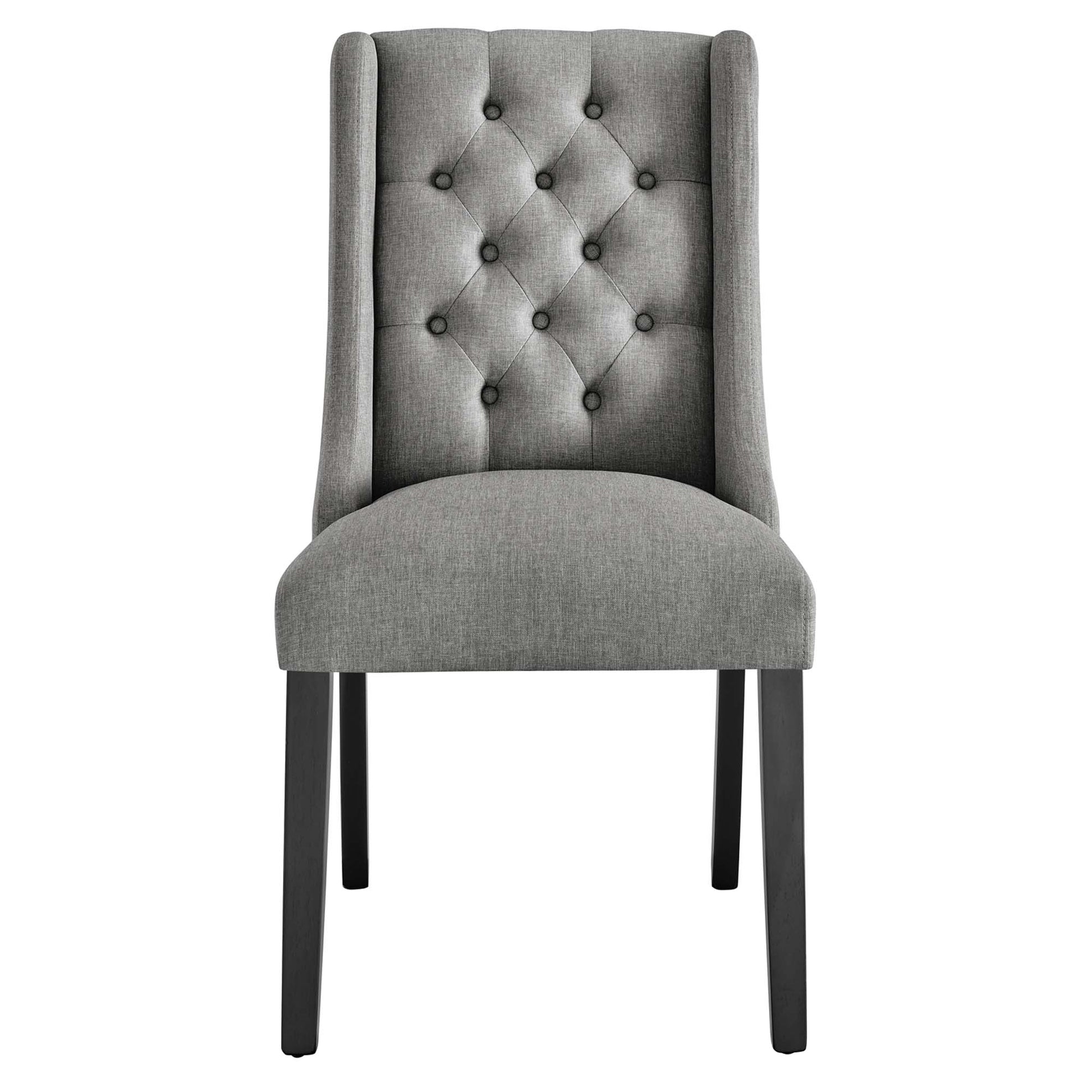 Gray fabric button-tufted dining chair with tall back, cushioned seat, black legs.