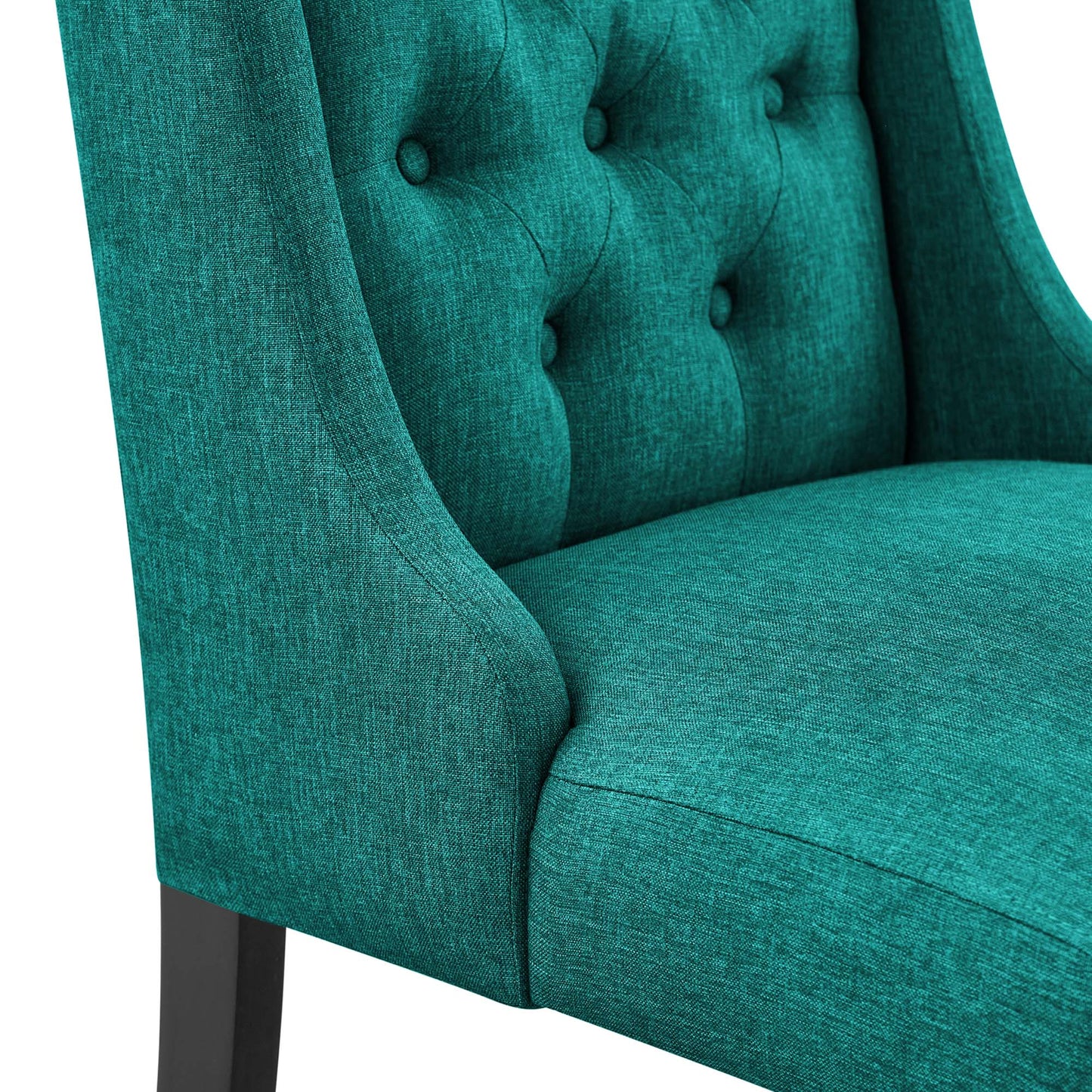 Teal fabric upholstered dining chair with tufted back and buttons, curved arms, and dark wood legs.
