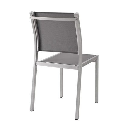 Silver-gray aluminum dining chair with mesh back and solid seat, modern outdoor patio furniture.