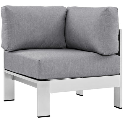 Outdoor aluminum corner sectional sofa with a silver frame and light gray cushions.