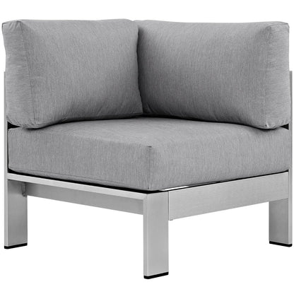 Gray outdoor aluminum corner sectional sofa with cushioned seats and a silver metal frame with square legs.