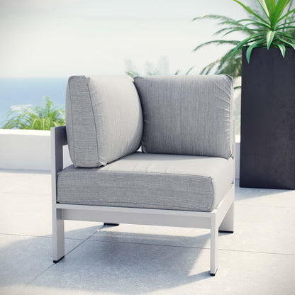 Outdoor aluminum corner sofa with light gray cushions.