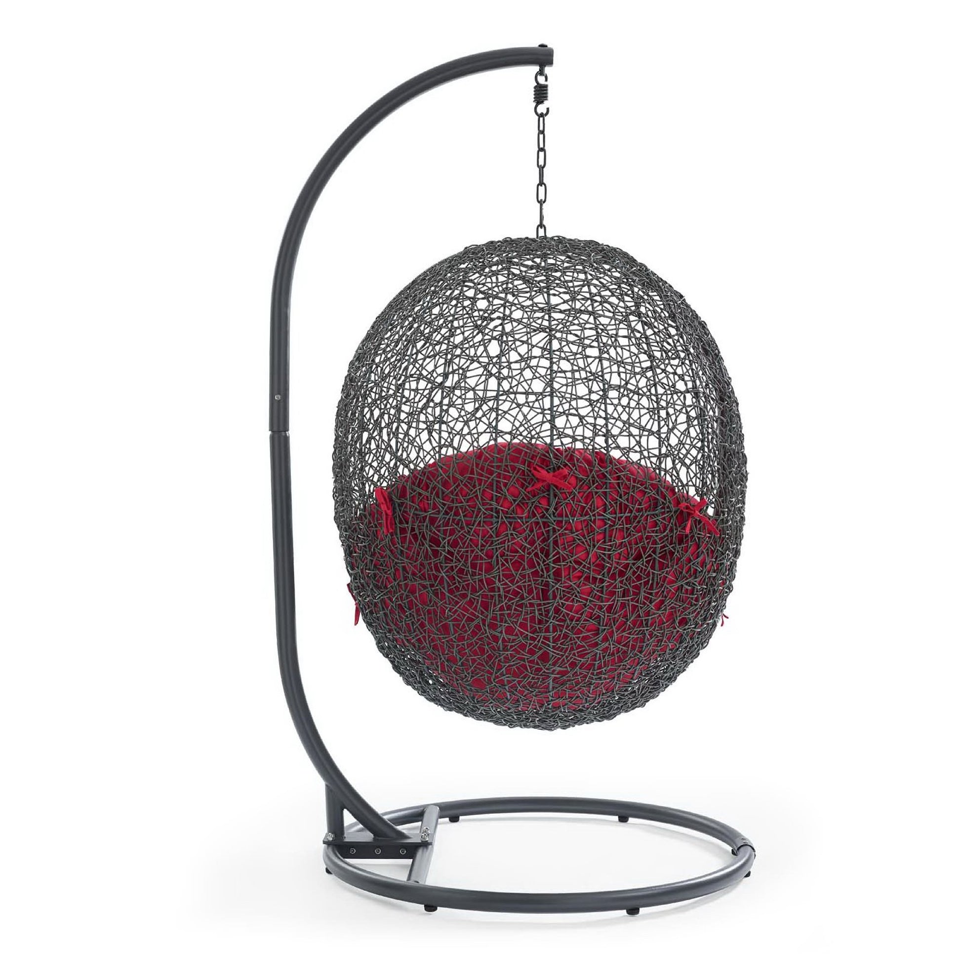 Gray metal outdoor swing chair with red cushion, suspended from a curved stand with chain.