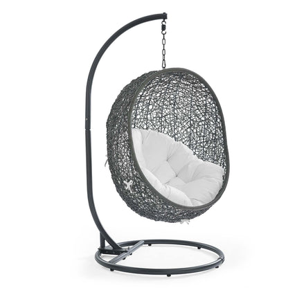Gray woven egg chair with white cushion hanging from black curved metal stand.