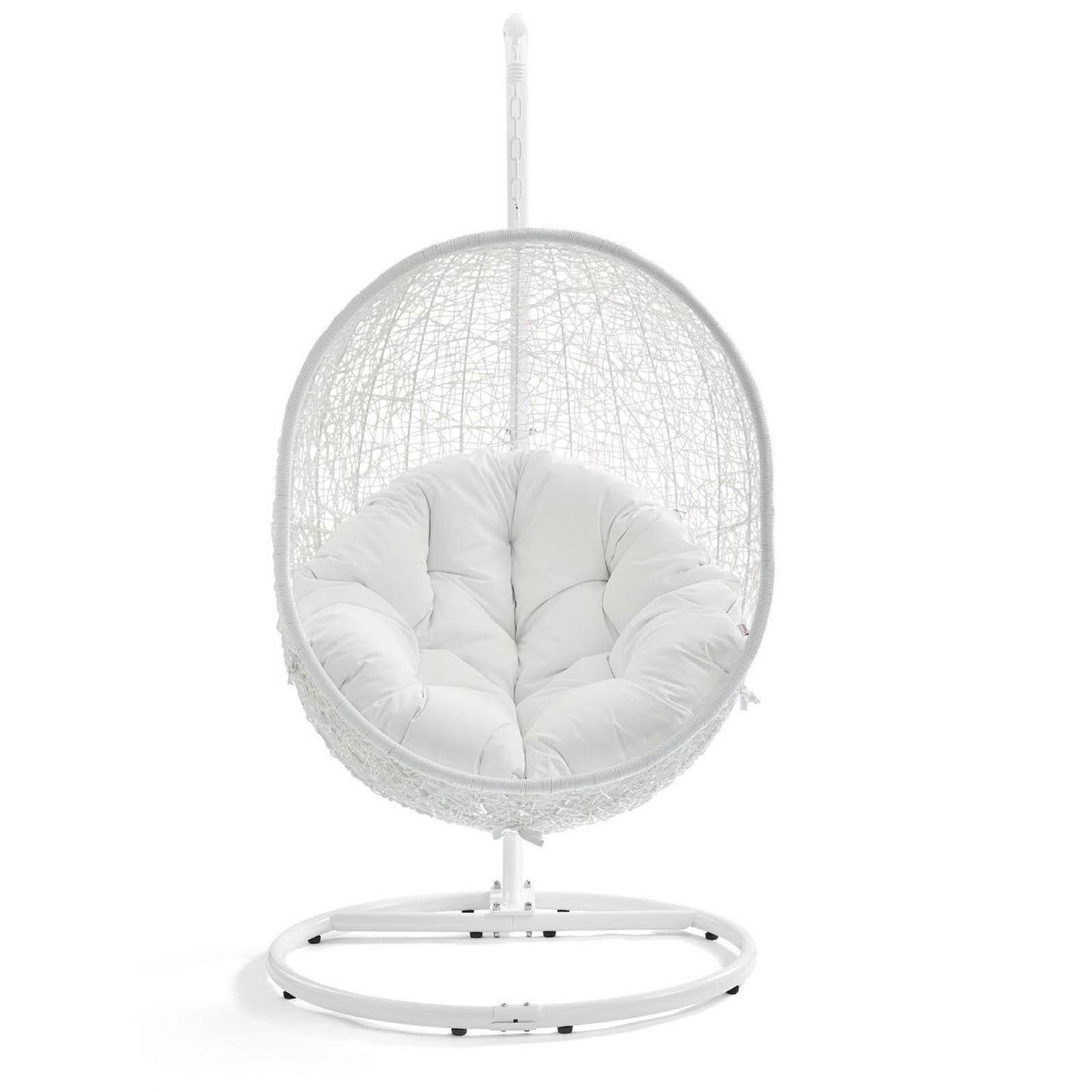 White hanging egg chair with woven rattan frame and plush white cushion on a circular metal stand.