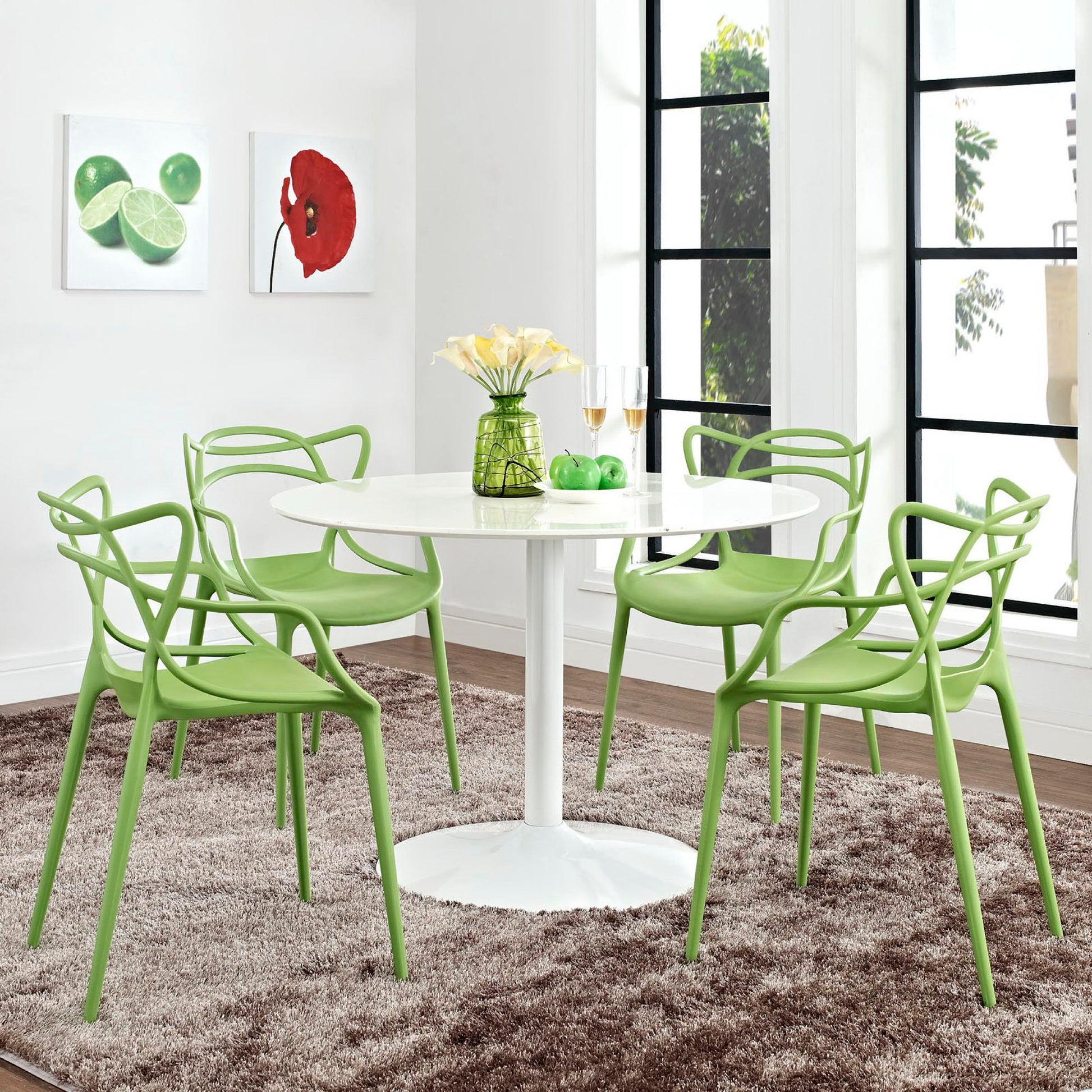 Lime-green modern dining chairs surround a white round pedestal table with a vase of flowers in a bright dining area.