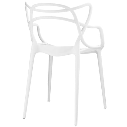 White molded plastic dining chairs with curved backs and armrests, slender legs, stackable modern design.
