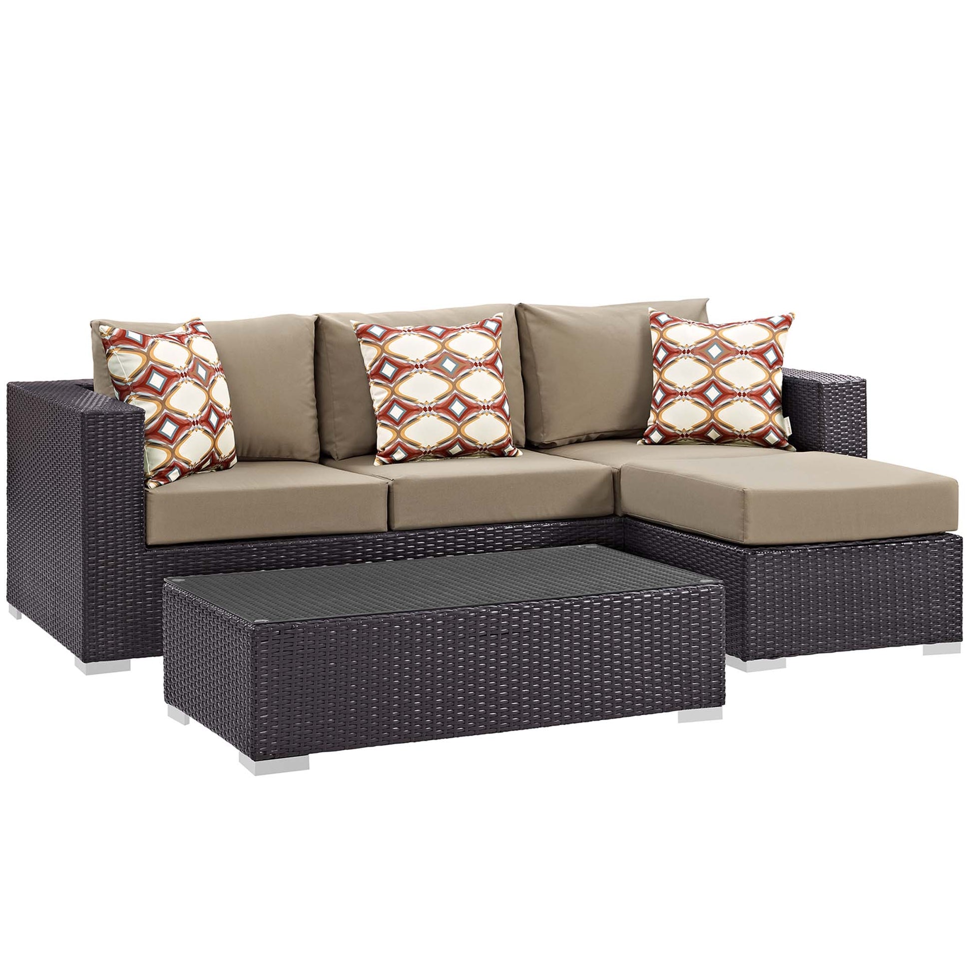 Dark brown wicker outdoor sectional with tan cushions, geometric-patterned pillows, & a glass-top coffee table.
