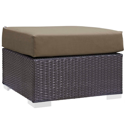 Dark brown woven rattan 3-piece outdoor patio sofa set with tan cushions; includes a rectangular ottoman and seating pieces on white square feet.
