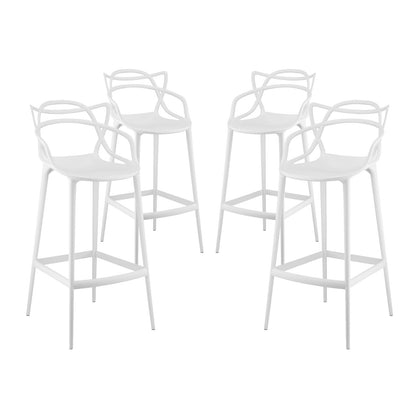 Four white metal bar stools with round seats and sculpted loop-back design.