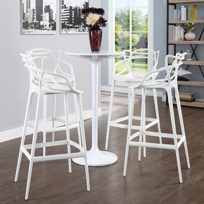 Set of four white metal bar-height stools with sculpted backs in a bright contemporary dining nook.
