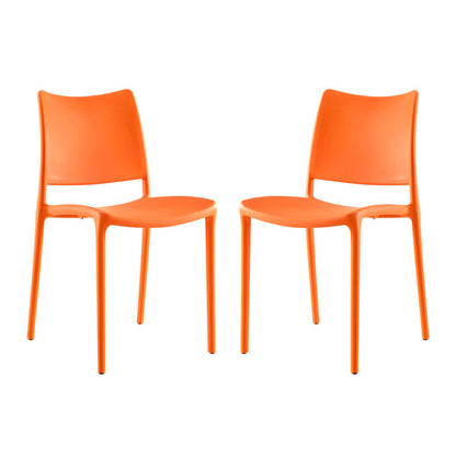 Pair of bright orange molded plastic dining chairs with curved backs and slender legs for modern casual seating.
