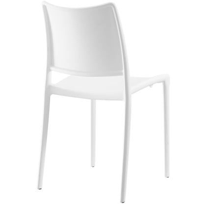 White molded plastic dining chair with curved backrest and slender legs, modern minimalist style.