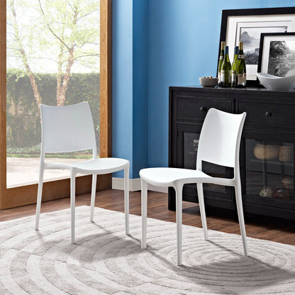 Set of two white modern molded-plastic dining chairs with curved backs and slender legs.