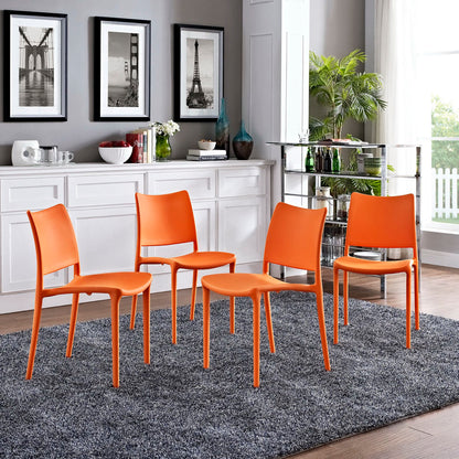 Set of 4 bright orange modern dining side chairs with curved backs on a gray rug in a contemporary dining area.