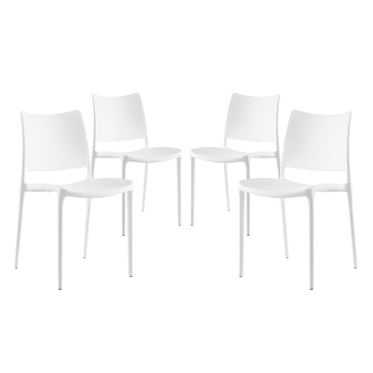 Set of four white molded-plastic dining side chairs with curved backs & slender metal legs.