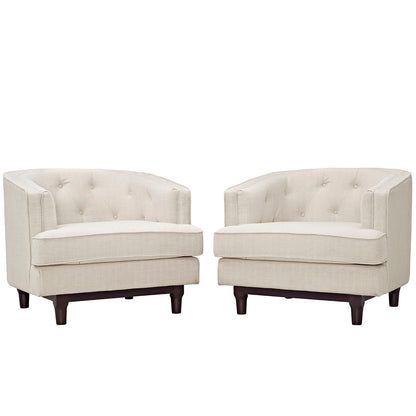 Pair of beige tufted fabric barrel chairs with curved arms, cushion seats, and dark wooden legs.