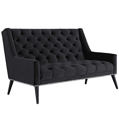 Black tufted velvet loveseat with nailhead trim along base, tapered legs, two-seater, plush back and seat cushions