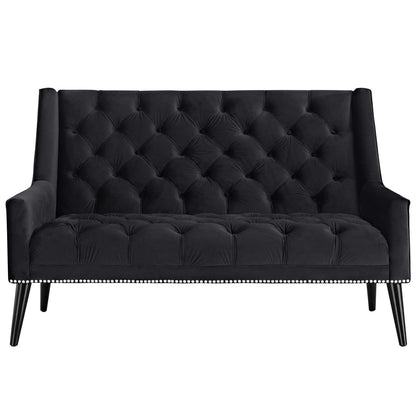 Black velvet tufted loveseat with button-tufted back and seat, nailhead trim along base, and tapered wooden legs.
