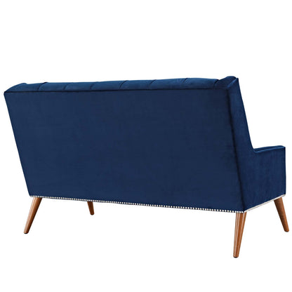 Navy blue velvet loveseat with tufted back, nailhead trim along base, mid-century wooden legs.