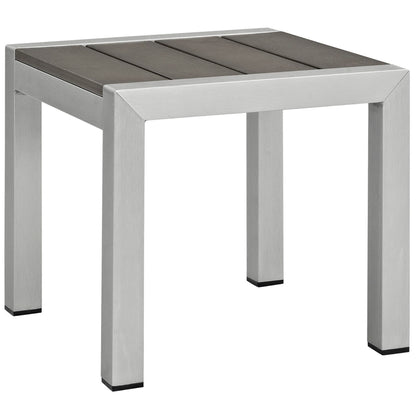 Modern silver metal-frame square side table with a dark gray wooden slat top; part of a gray outdoor patio sofa set.