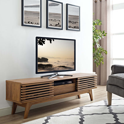Walnut mid-century TV console with slatted doors & open shelf, TV on top in a modern living room.