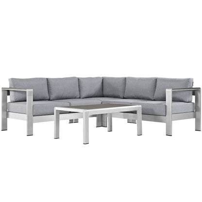 Slate gray outdoor sectional with a silver aluminum frame & light gray cushions, plus a rectangular coffee table.