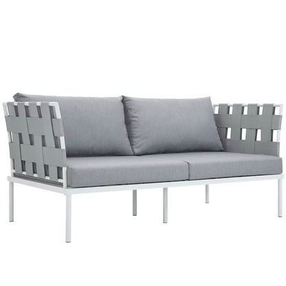 White aluminum outdoor loveseat with gray woven panels and two light gray cushions.