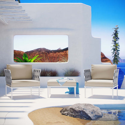 Outdoor white patio aluminum 3-piece sectional sofa set with beige cushions and a white coffee table on a seaside terrace.