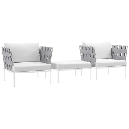 White outdoor patio seating set with two armchairs, a matching ottoman, gray woven backs, and light gray cushions.